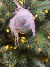 Load image into Gallery viewer, Clear iridescent glass ball decoration with feather detailing.
