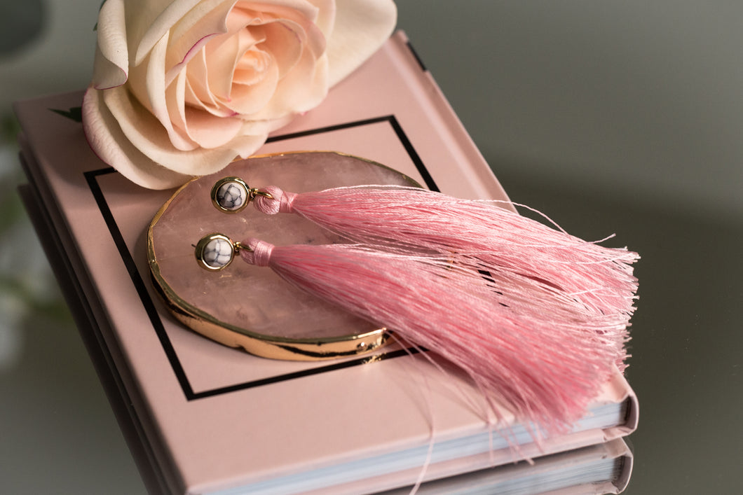 Marble effect earrings with long pink tassels.